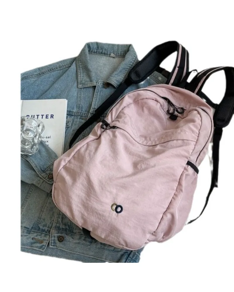 

Light Pink Casual Backpack with Minimalist Design Water Resistant Fabric Suitable for Daily School Work and Casual Use
