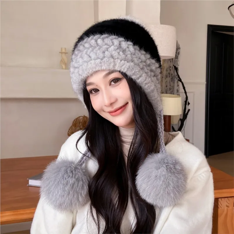 A fur hat for women is warm fashionable cute and versatile in autumn winter knitted with pom-poms