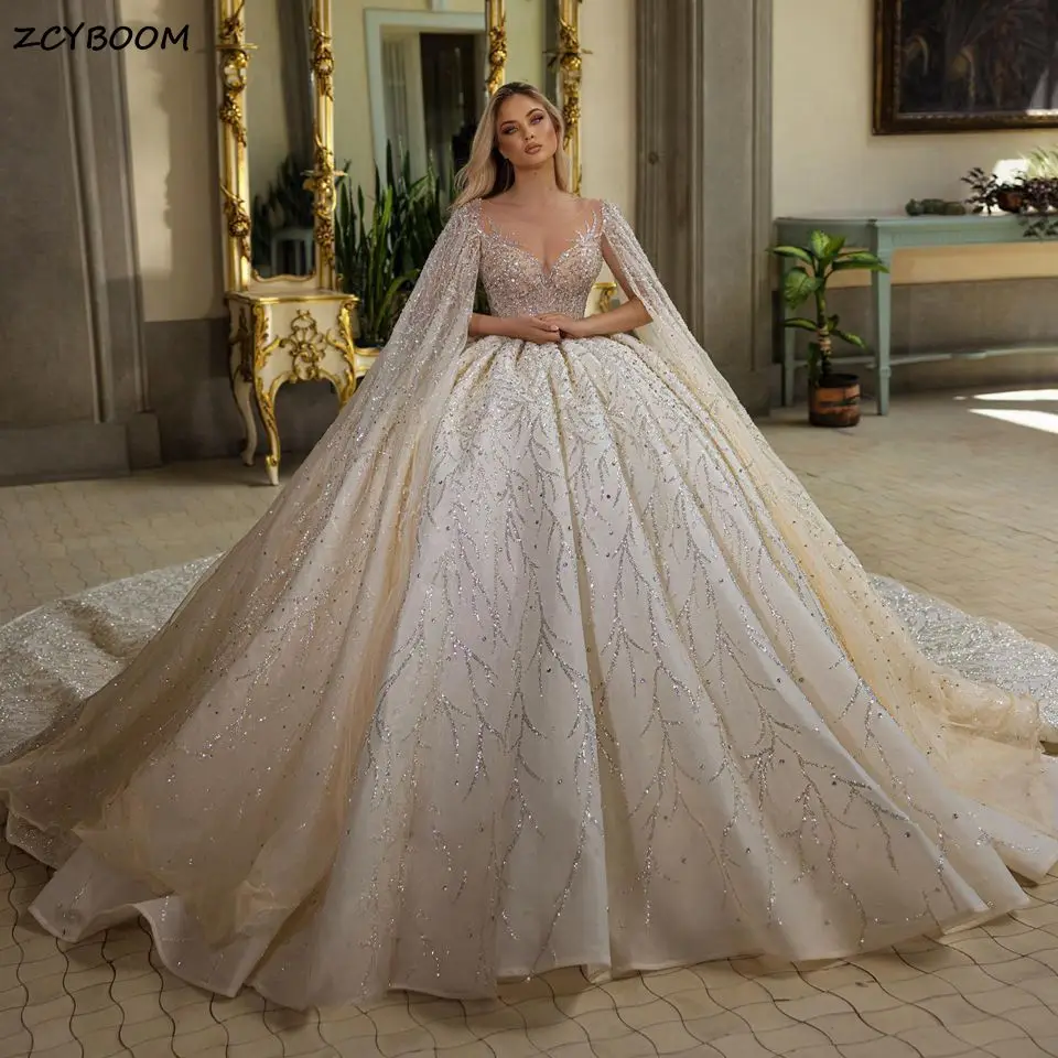 

2023 Exquisite V-Neck Ball Gown Wedding Dresses With Cape Princess Sparkly Sequined Crystals Beaded Bride Gowns Vestido De Noiva