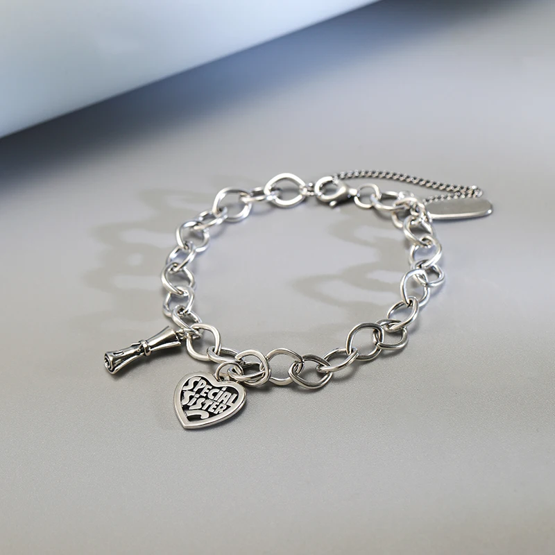 

Genuine 925 sterling silver Forged Link Charm Bracelet paired with a diploma and a "special sister" heart pendant