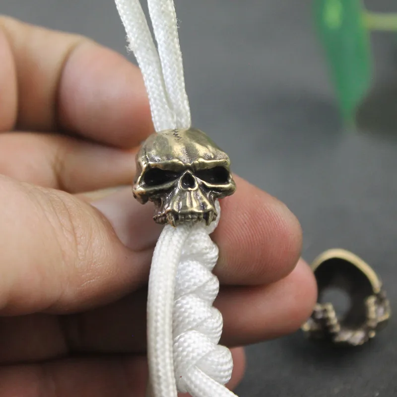 ไม่มีคางหัวกะโหลกทองเหลืองมีดพังก์ย้อนยุค DIY paracord สร้อยข้อมืออุปกรณ์เครื่องมือ EDC กลางแจ้งจี้สายคล้องเชือกปีนเขา