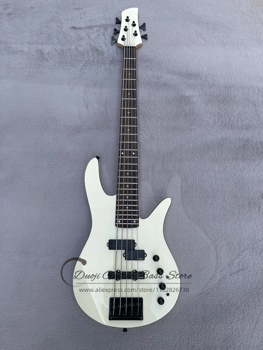 5 string cream bass guitar,  black fixed bridge, solid wood body with black binding, rosewood fretboard, customizable color