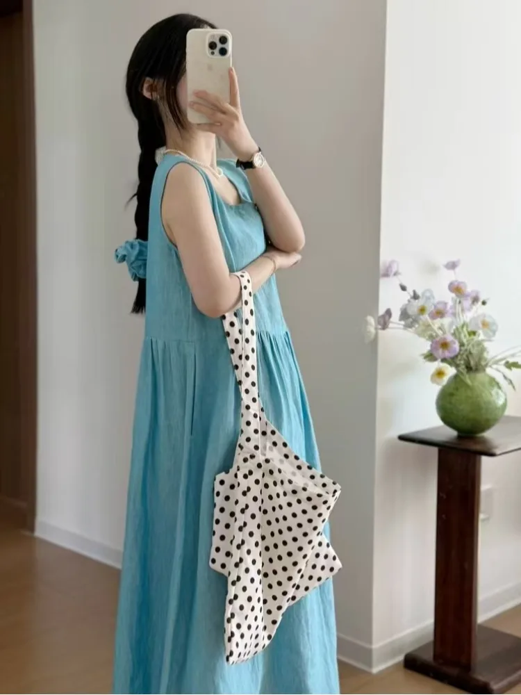 فستان صيفي كاجوال بدون أكمام من القطن والكتان للنساء، تنورة طويلة واسعة فضفاضة برقبة مستديرة وتصميم على شكل حرف A بلون موحد