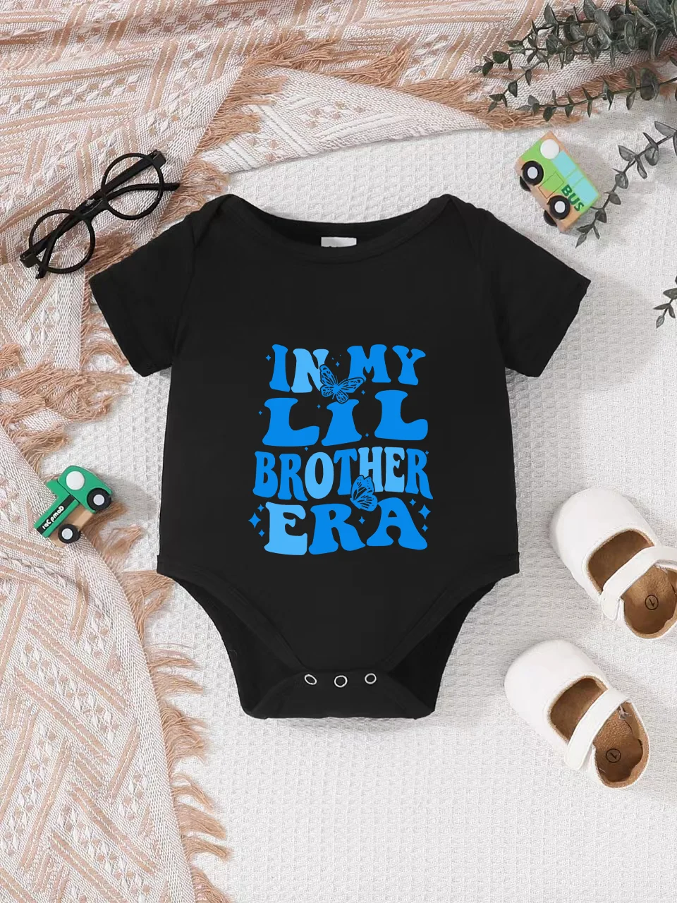 Playful letter-printed baby short-sleeve triangle bodysuit. Button closure for easy dressing, machine washable