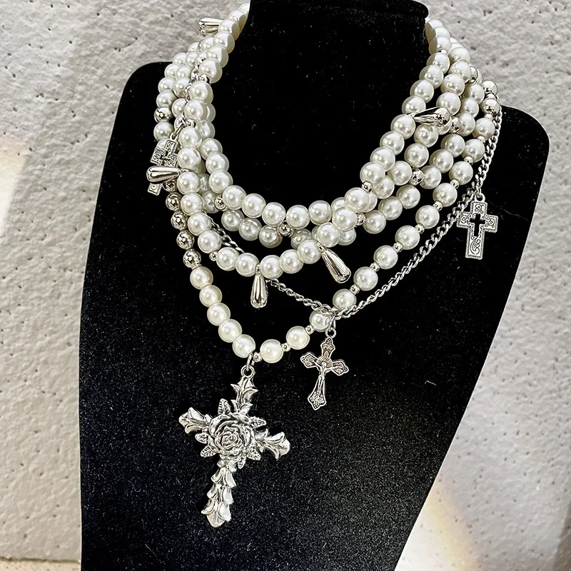 Pearl beaded necklaces are layered with men\'s and women\'s sweaters