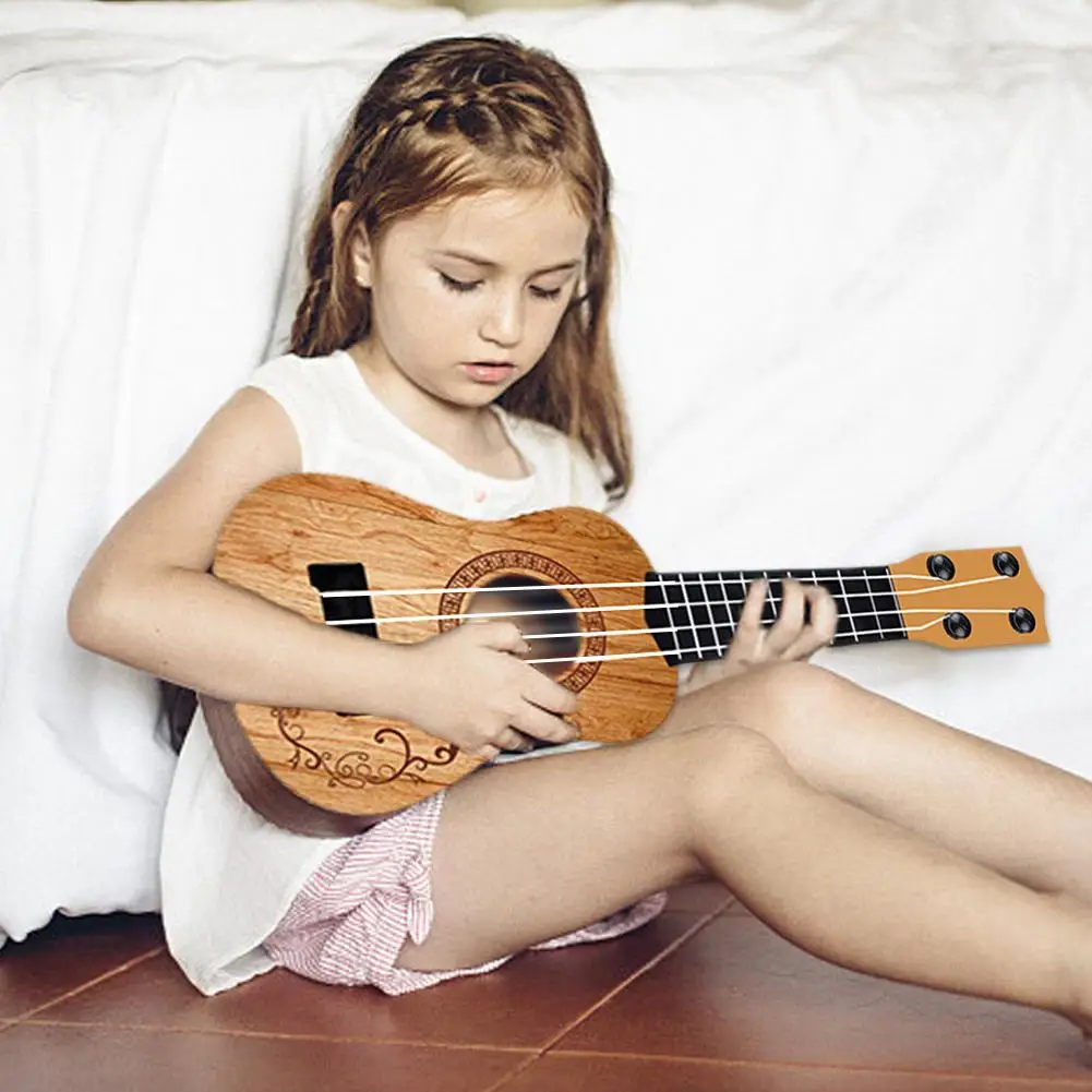 Mini chitarra 4 corde chitarra classica Ukulele educazione della prima infanzia giocattolo strumenti musicali regali di compleanno per bambini