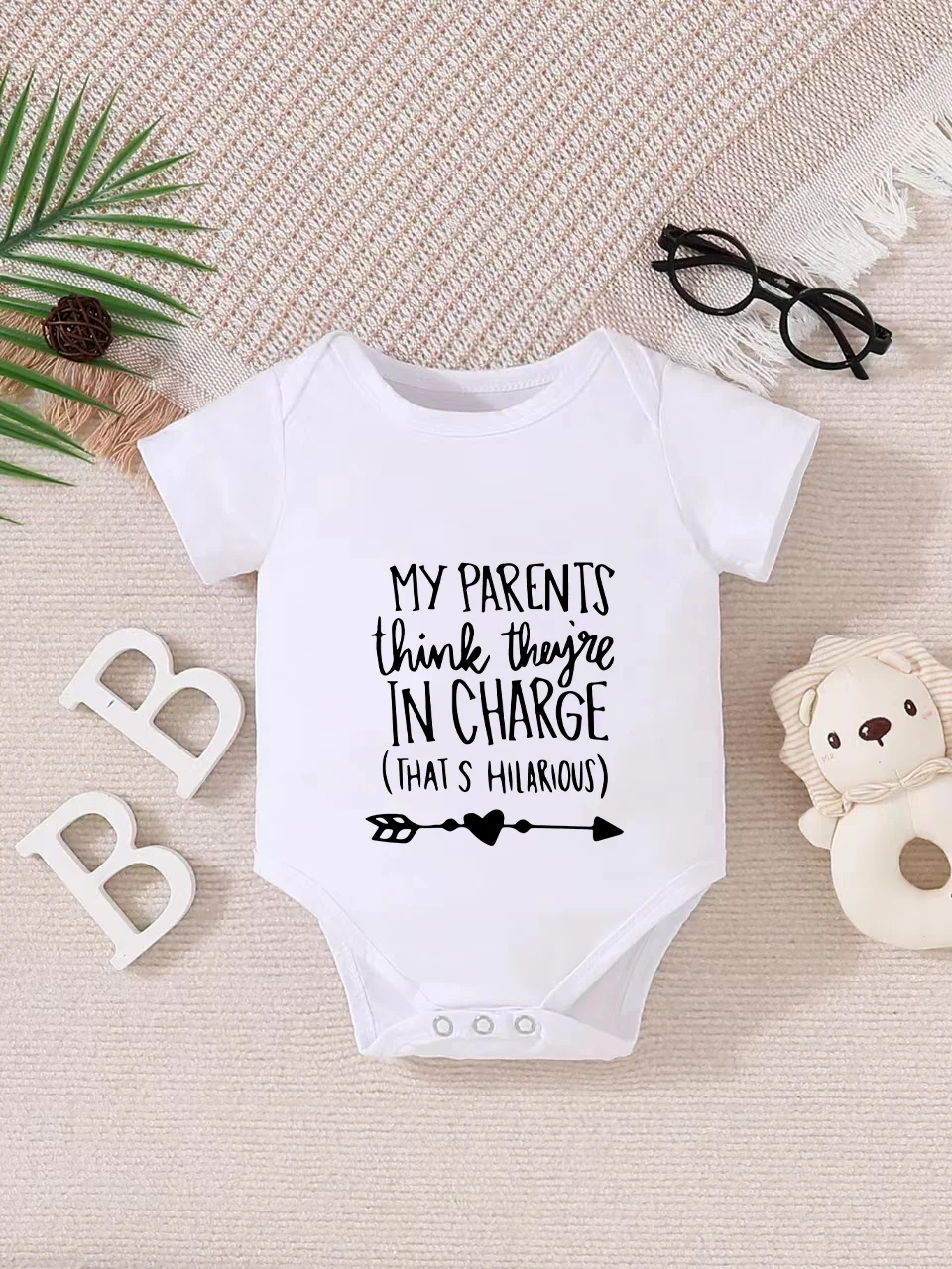 Playful letter-printed baby short-sleeve triangle bodysuit. Button closure for easy dressing, machine washable