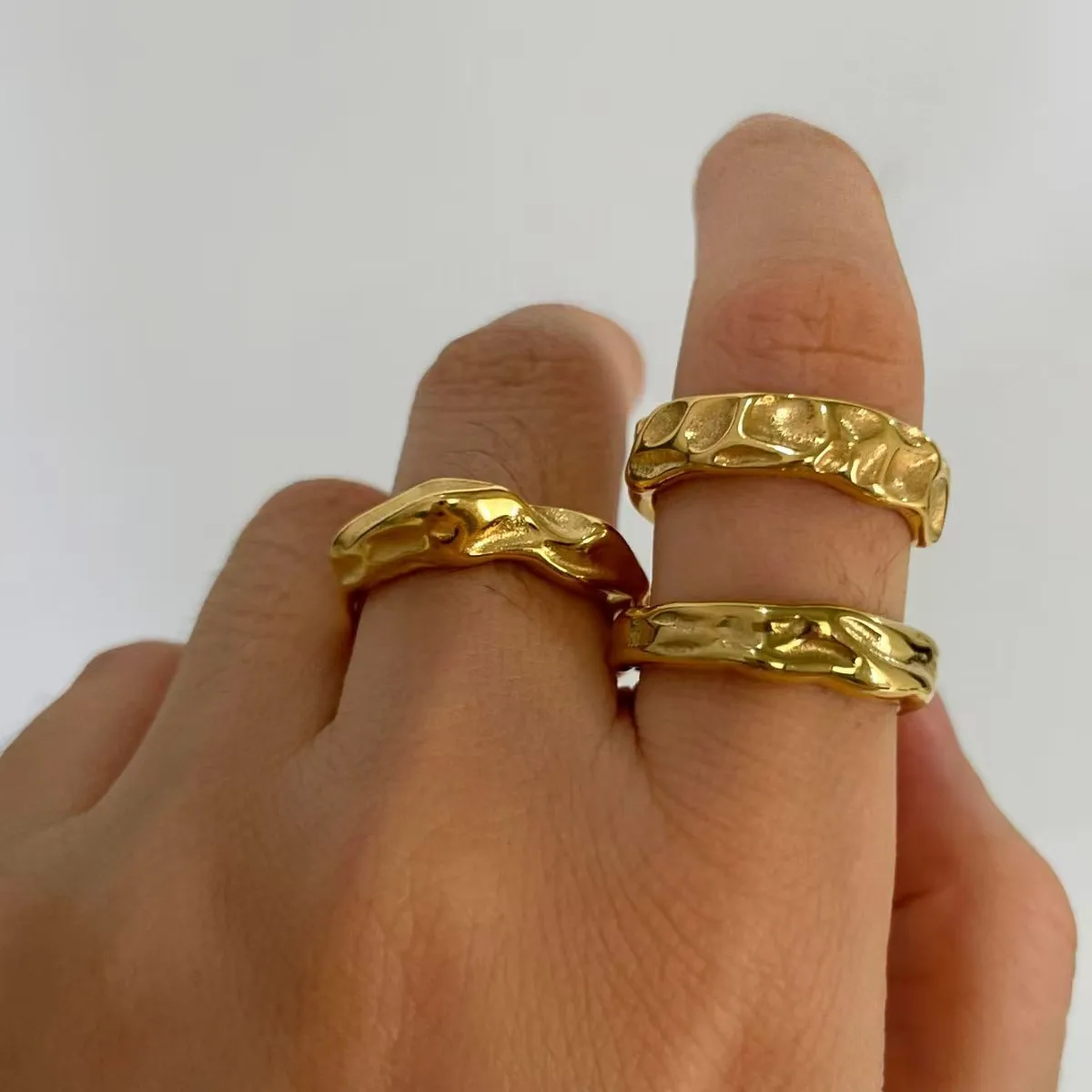 Three-piece set of trendy and minimalist titanium steel rings with lava-patterned, wrinkled, and irregular designs.