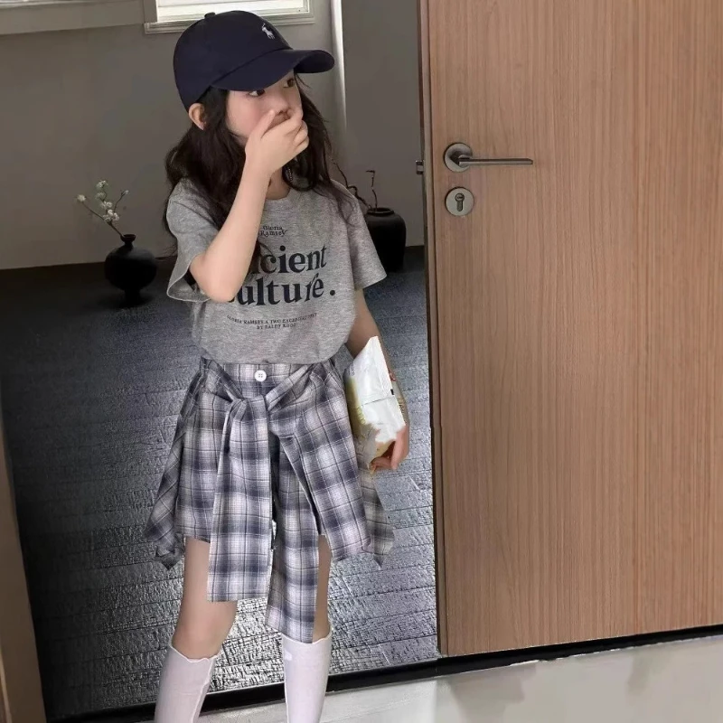 

2025 Summer New Style for Girls: Stylish Lightweight T-Shirt and Plaid Skirt Two-Piece Set.