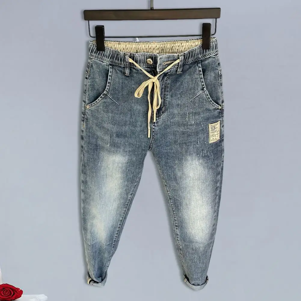 Jeans harém estilo hip-hop masculino, elástico na cintura, cordão ajustável, calças jeans com zíper, bolsos para um