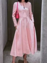 Retro elegance pink round neck long sleeve bow tie dress 2024 women's autumn new high waist and long A-line skirt.