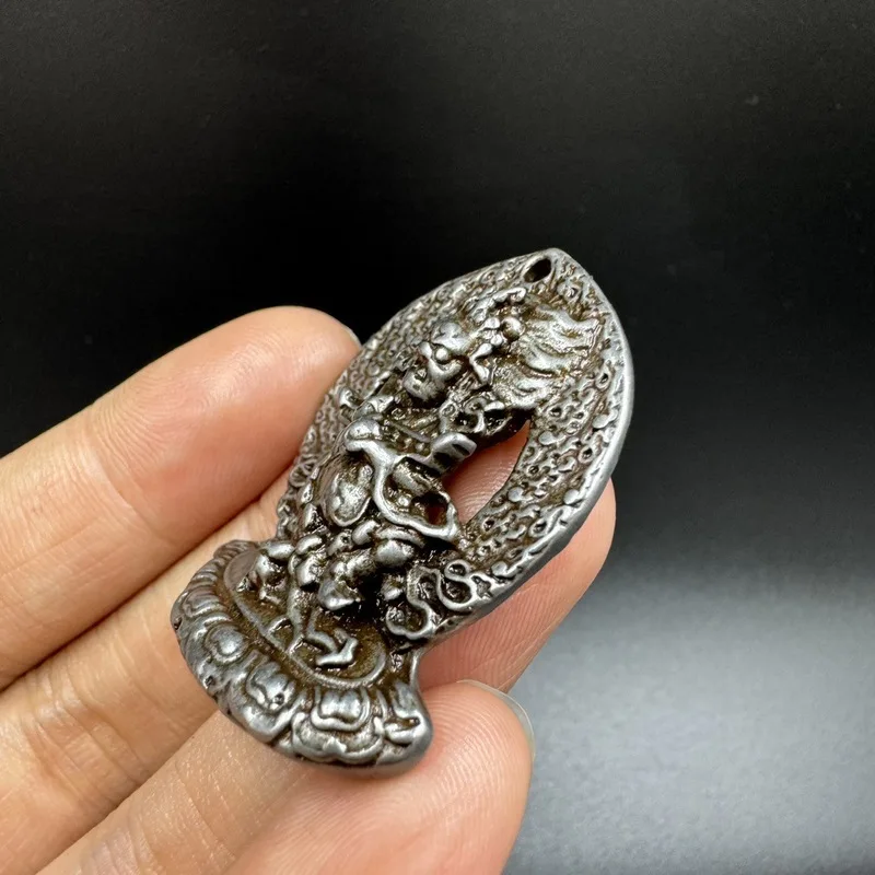 Nepalese -style iron pendant, hand-hammered and engraved, with a protective shell, depicting the Tibetan Buddha Ma