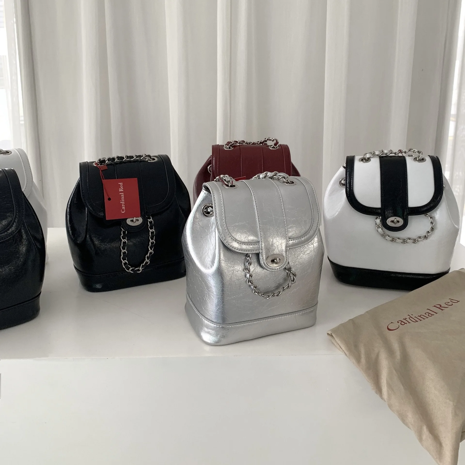 

Cardinal Red bag from South Korea, a retro fashion chain leather backpack for women