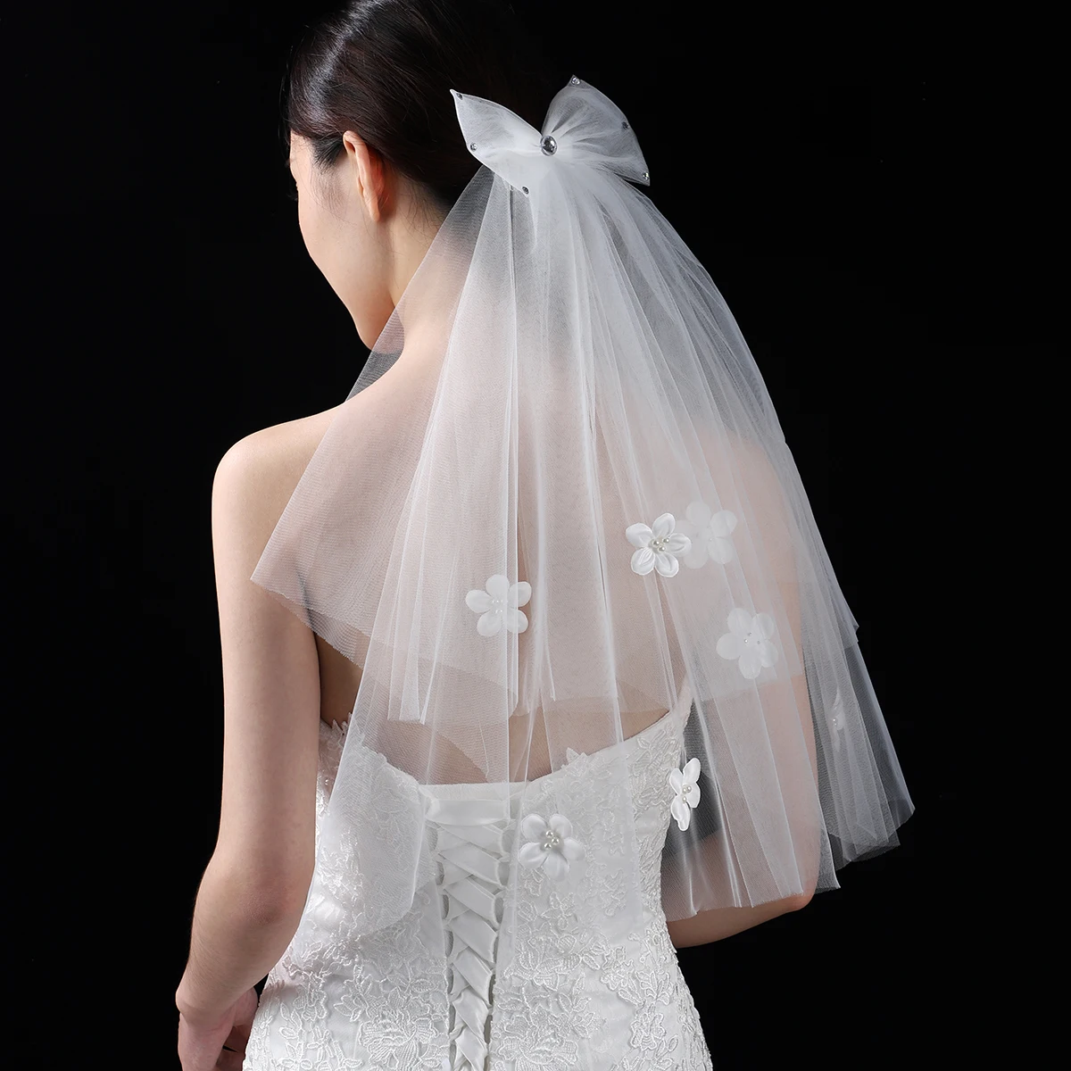 A white elegant bridal veil adorned with a bow, suitable for women's wedding waist length veils