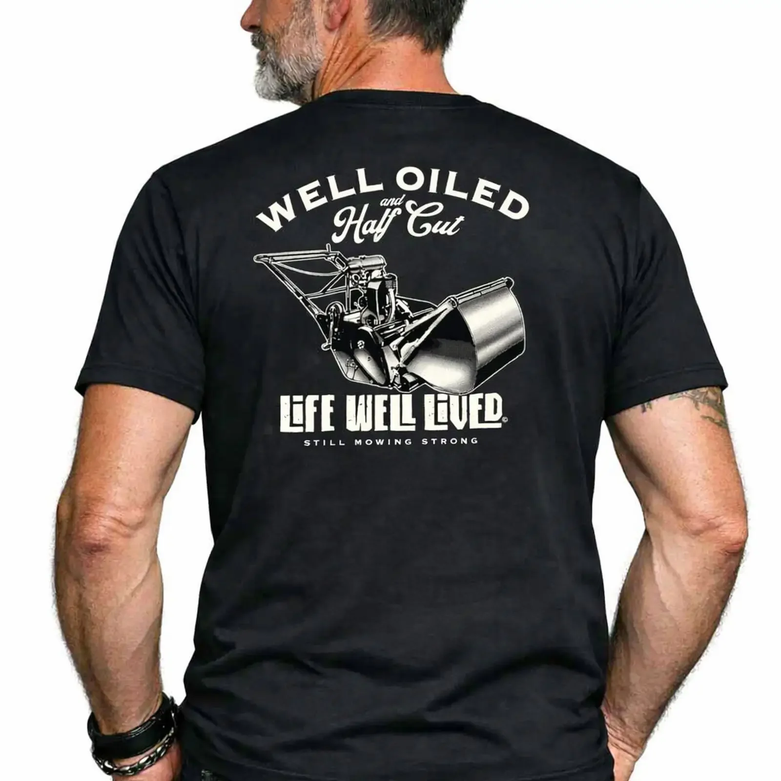 Man wearing the Well Oiled Half Cut black T Shirt showing bold lawnmower back print vintage Washed homme Versatile graphic Soft