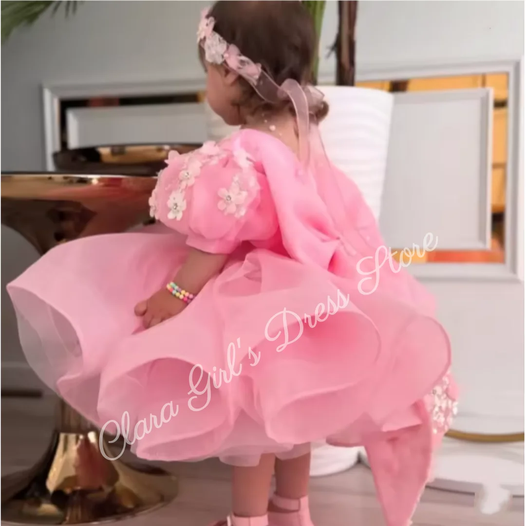 

Adorable pink flower girl dress with a large bow and floral decorations, suitable for toddlers' first communion and wedding part