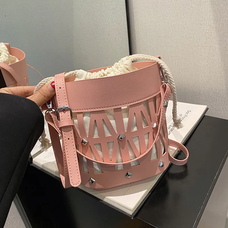 Bolso de hombro de PU hueco de diseño Popular de este año para mujer, bolso de mensajero portátil, bolsos de cubo, versión coreana de moda pura de verano