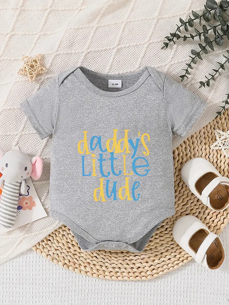Playful letter-printed baby short-sleeve triangle bodysuit. Button closure for easy dressing, machine washable