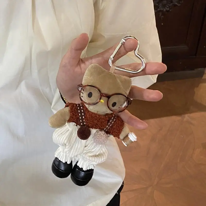 Sanrio salopette pour Hello Kitty porte-clés en peluche dessin animé lunettes créatives portant une poupée à longues jambes sac à dos fermeture éclair pendentif décoration