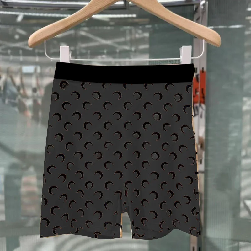 [black moon shorts on black background]