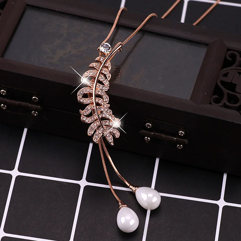 Multi-functional and personalized sweaters, long chain necklaces, and women's feather tassel pendants