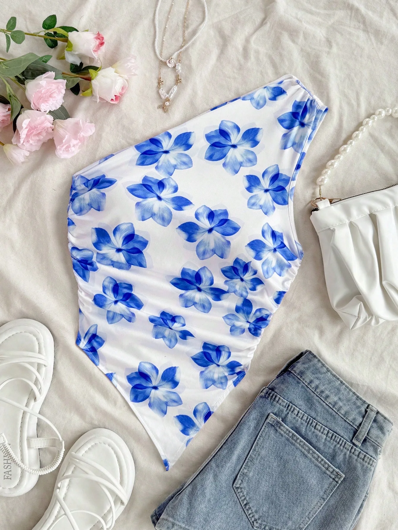 This Stylish Top Features Beautiful Floral Print, Trendy One-Shoulder Style and Delicate Ruched Details. The Asymmetric Hem Crea