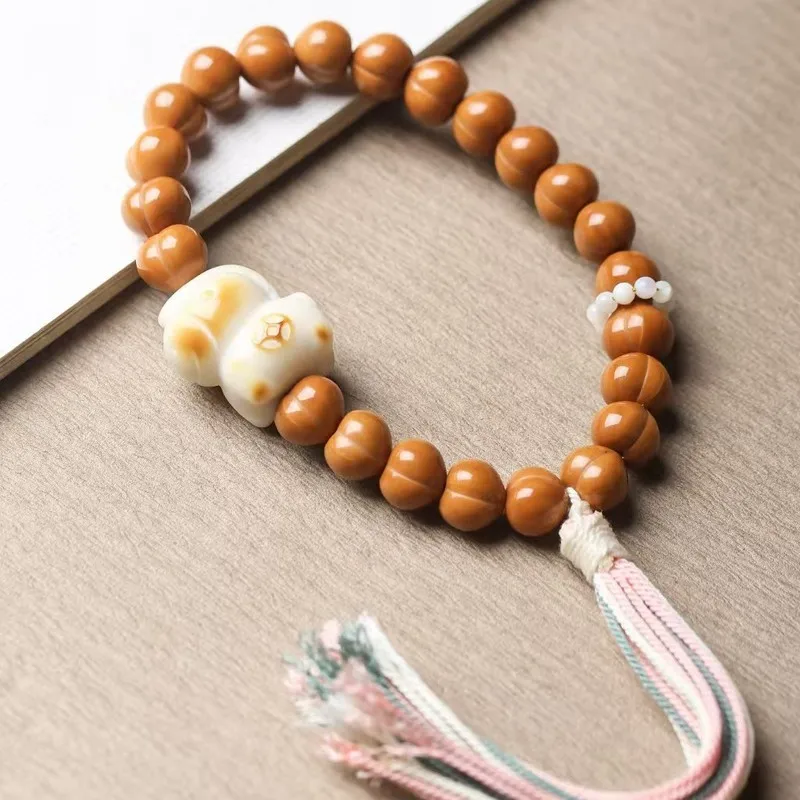 Exquisite monkey carving, golden peach- , paired with ivory fruit and small horse-shaped beads in a bracelet