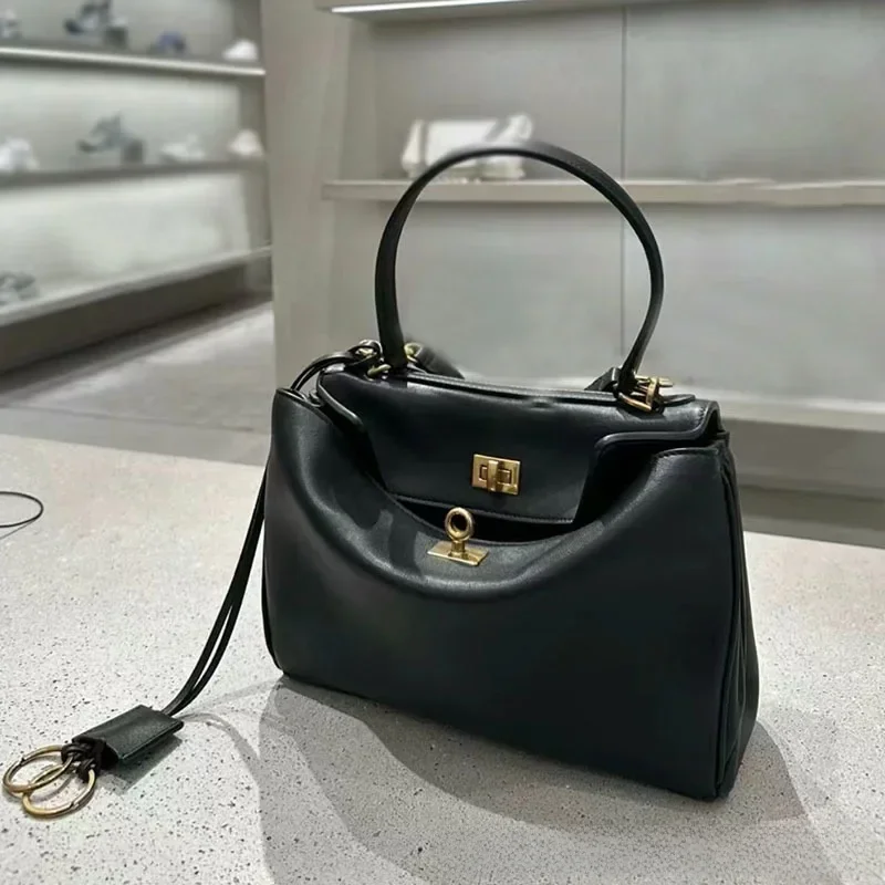 Rodeobag-Bolso de cuero genuino para mujer, bandolera cruzada inclinada, con hebilla de bloqueo, para las axilas, color dorado y negro, novedad