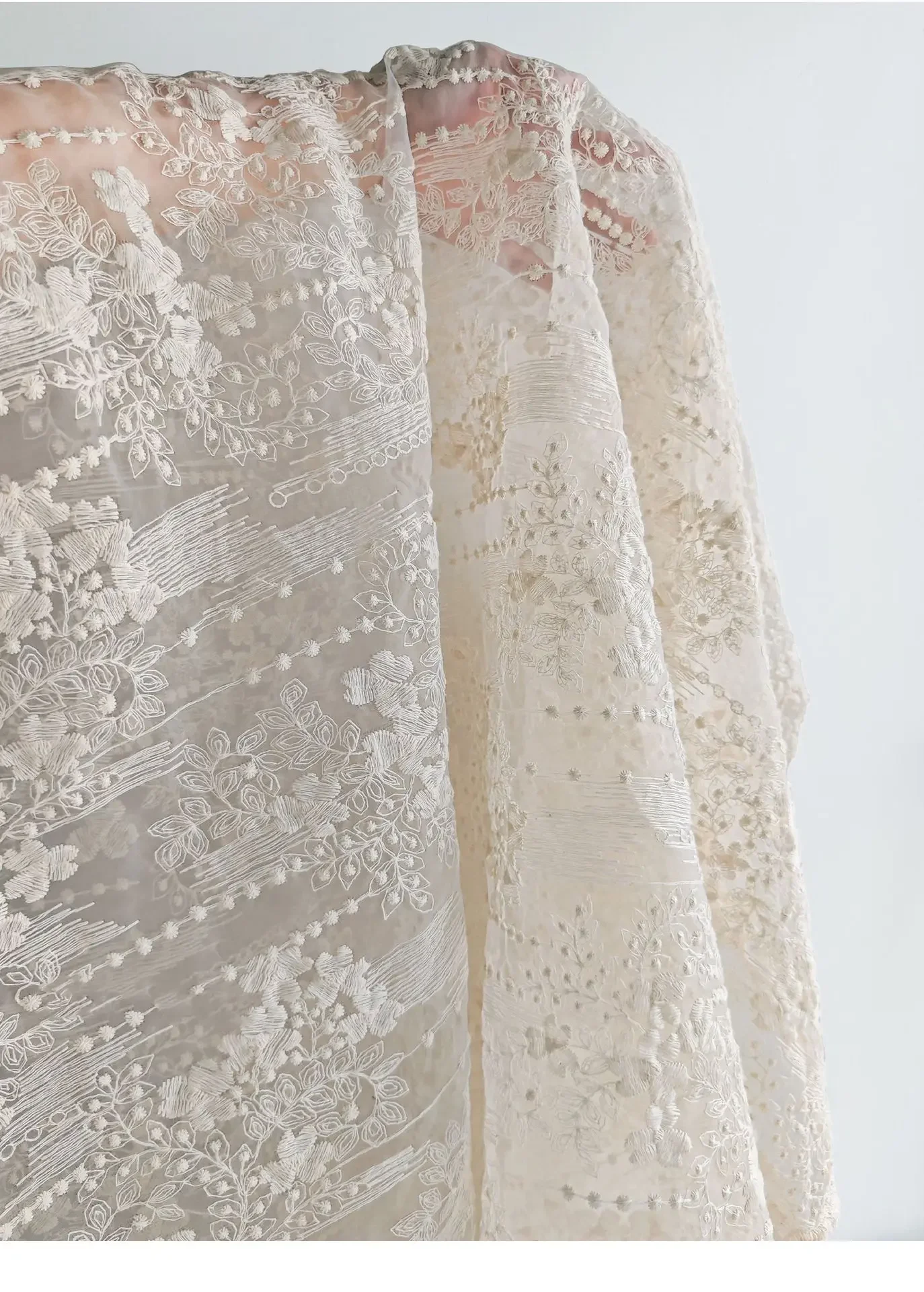 High quality Organza lace fabric with embroidered small floral patterns in apricot color, used for bridal gown designers