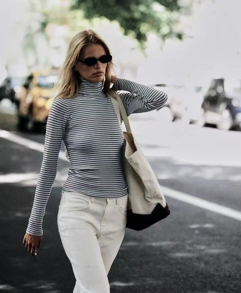 Frankies blue and white striped slim knit sweater with a high neckline as a base, making women look slimmer