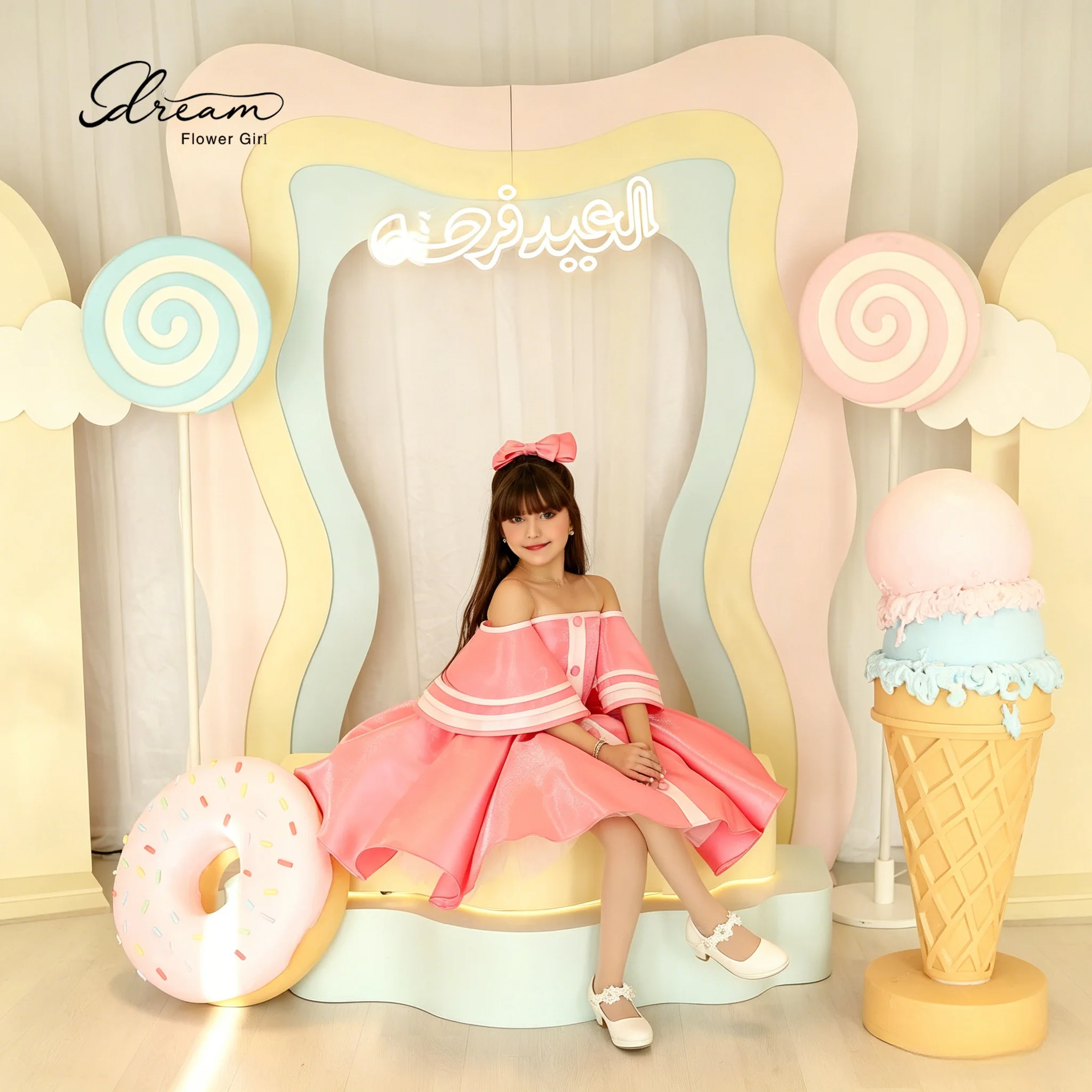 Pink knee-length formal party dress for girls featuring a flat collar short sleeves a full skirt and draped detailing