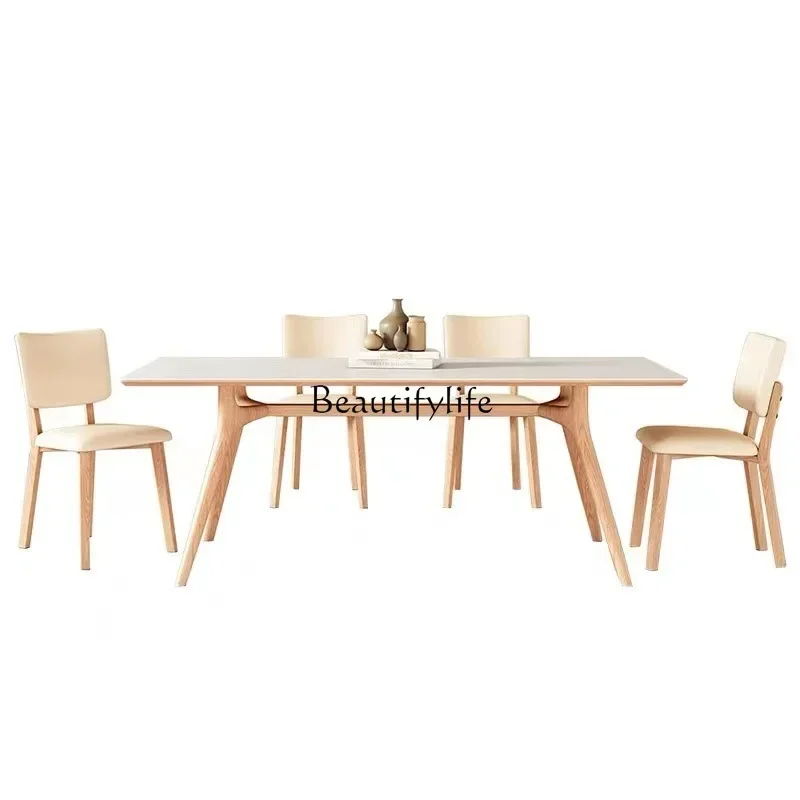 

Solid wood rock slab dining table Small apartment Modern simple solid wood legs Pure white rock slab dining table and chairs