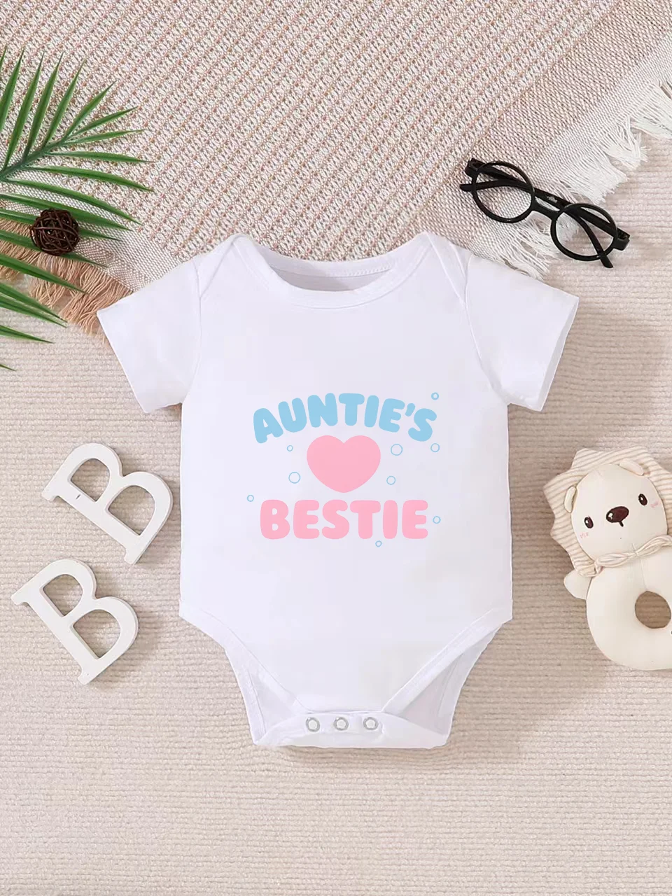 

Playful letter-printed baby short-sleeve triangle bodysuit. Button closure for easy dressing, machine washable