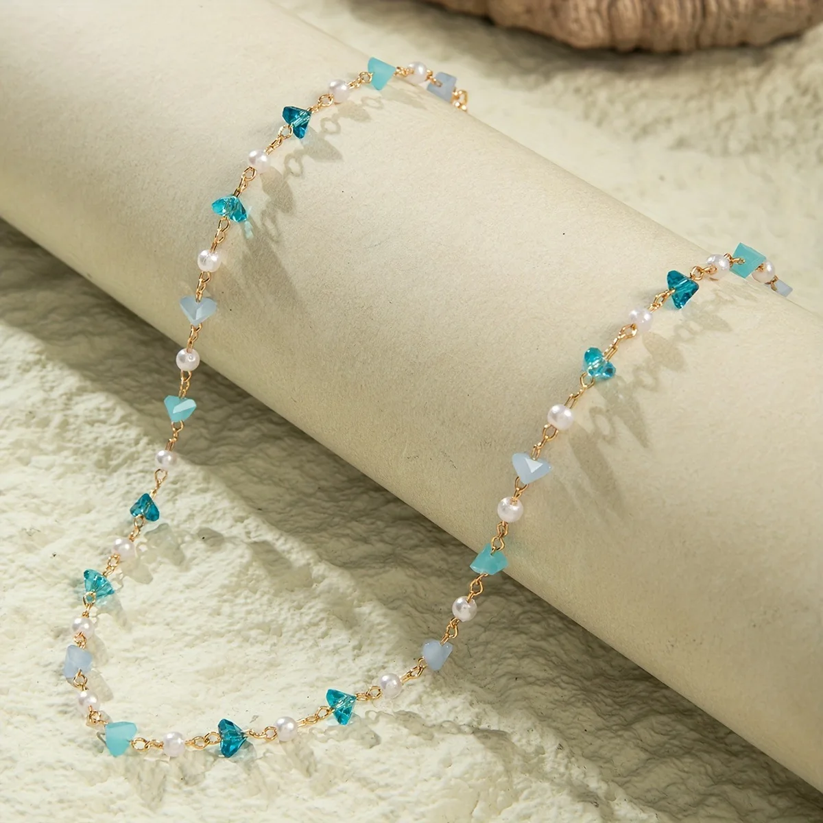 Minimalist and elegant geometric pebble pendant choker necklace with fauxpearl inlay, a delicate clavicle chain.