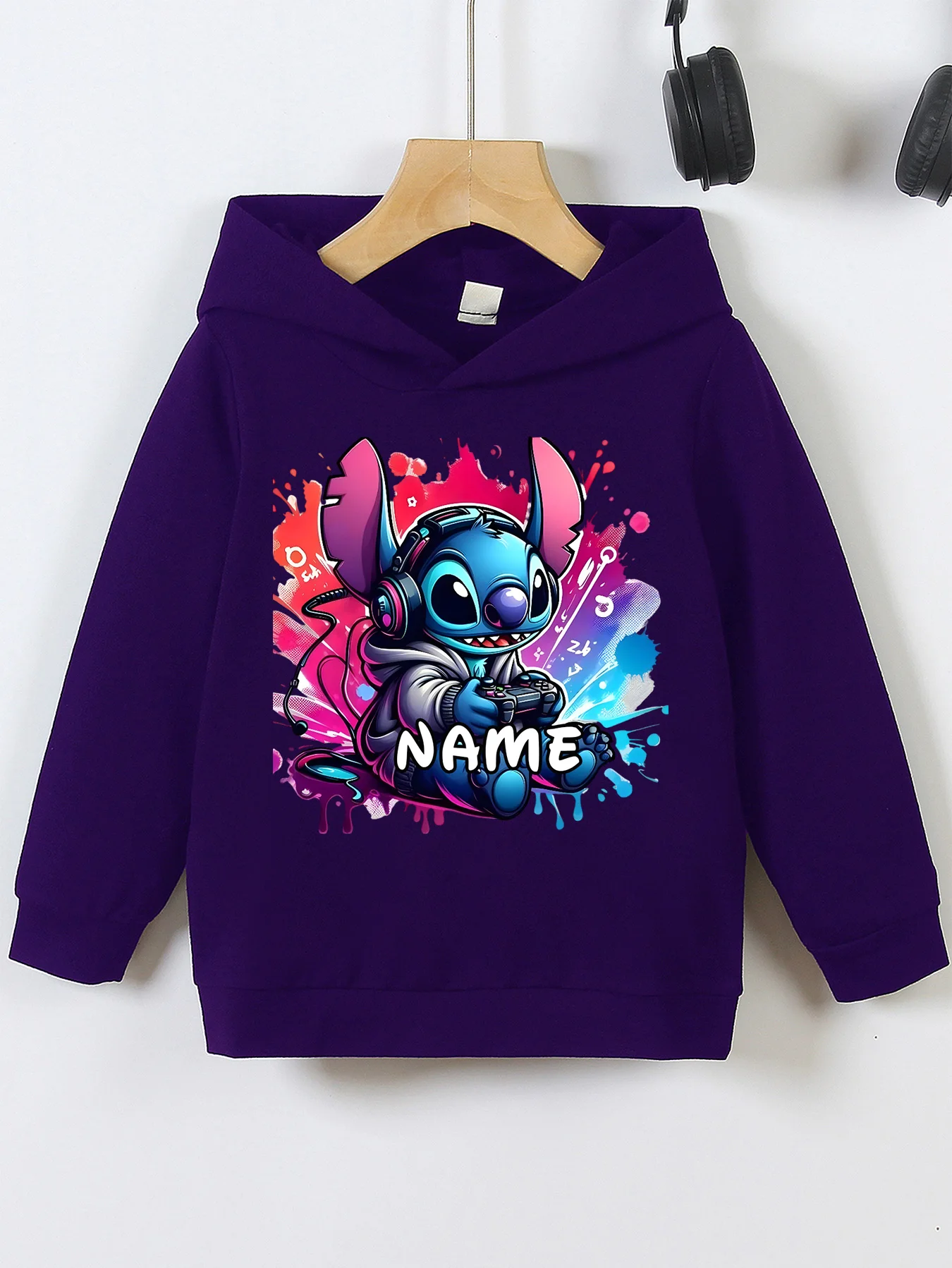MINISO Stitch Video Game Hoodie - Stitch plays games with headphones and a colorful splash-ink design featuring the character 