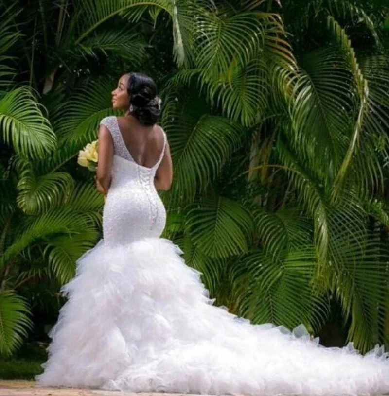 Maßgeschneiderte afrikanische Plus Size Meerjungfrau V-Ausschnitt Bling Perlen abgestufte Rüschen Brautkleider Kapelle Zug Brautkleid