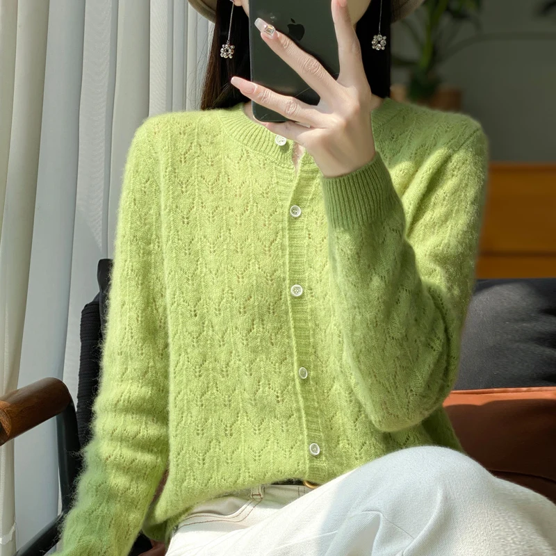 Autumn and winter new 100% pure wool cardigan female O-neck hollow crocheted solid color long sleeve sweater loose sweater coat.