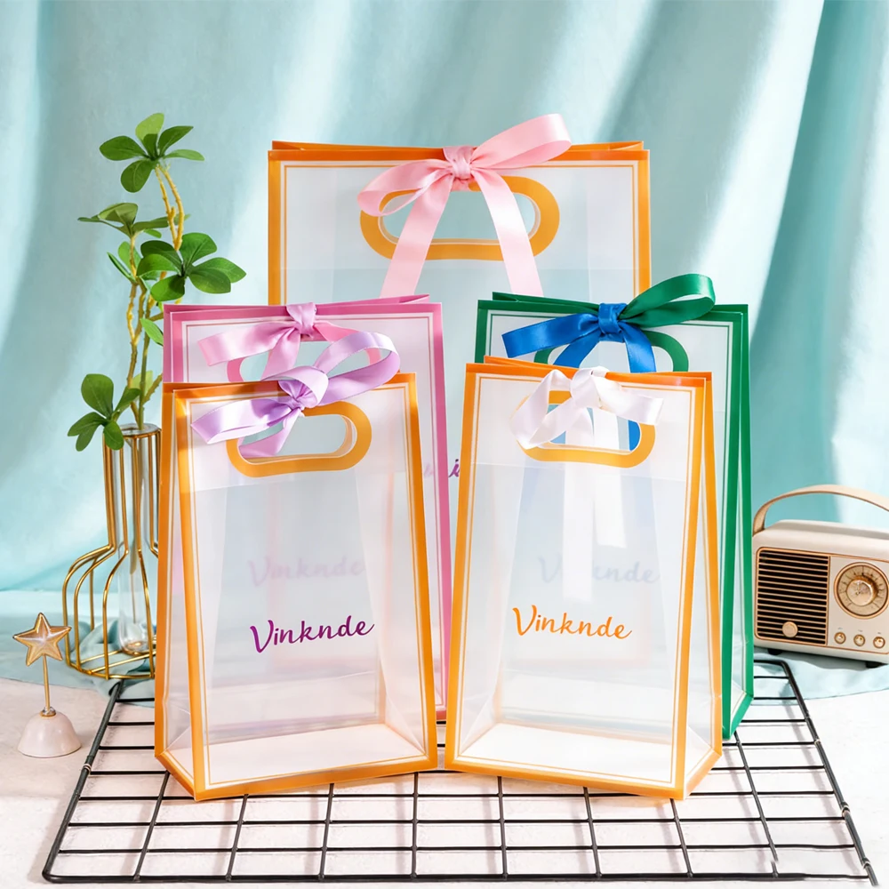 

Premium Custom Logo PVC PP Tote Bags With Bow Ribbon Travel Organizer Perfect for Packaging Clothing Cosmetics Business Gifts