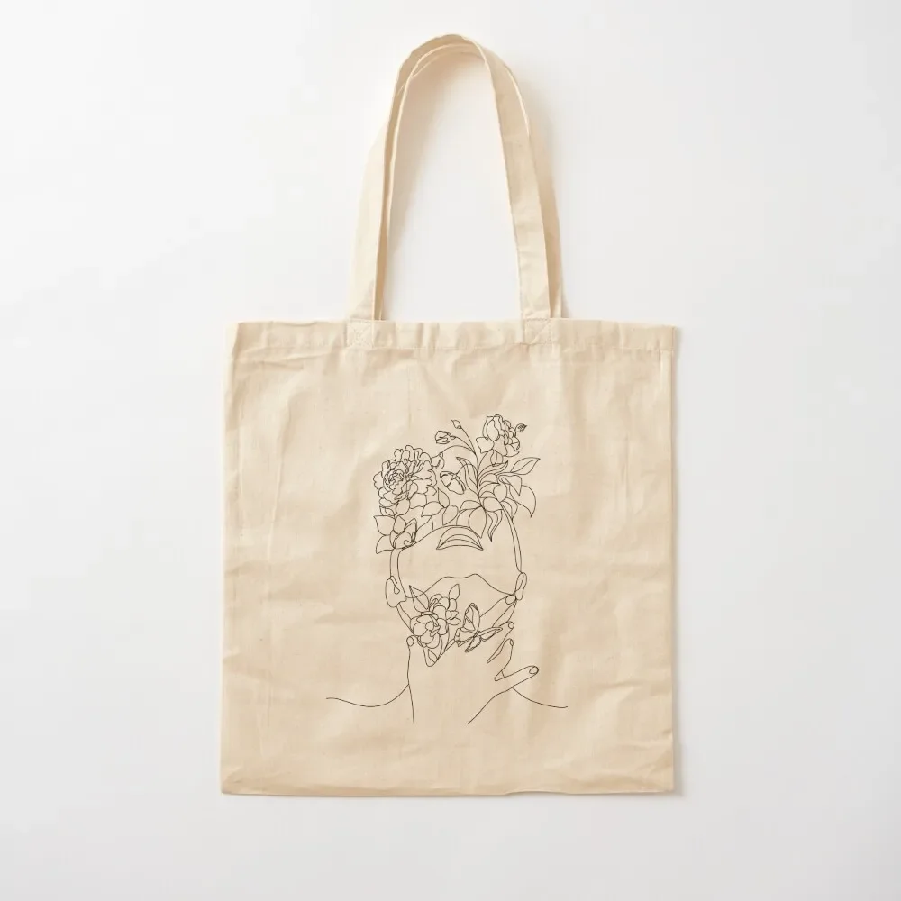 

Abstract face with flowers by one line drawing. Portrait minimalistic style. Botanical print. Nature symbol of cosmetic Tote Bag