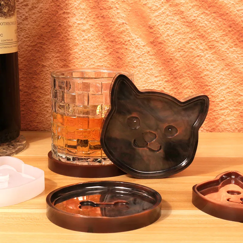 Silicone molds in the shape of bones and cats, made of epoxy resin can be used for insulation coasters and decorative plates