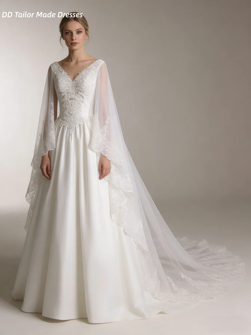 Suknia ślubna w stylu vintage, fason A, z peleryną, aplikacjami z koronki, dekolt w serek, bez rękawów, w kolorze kości słoniowej, tren dworski, możliwość personalizacji.