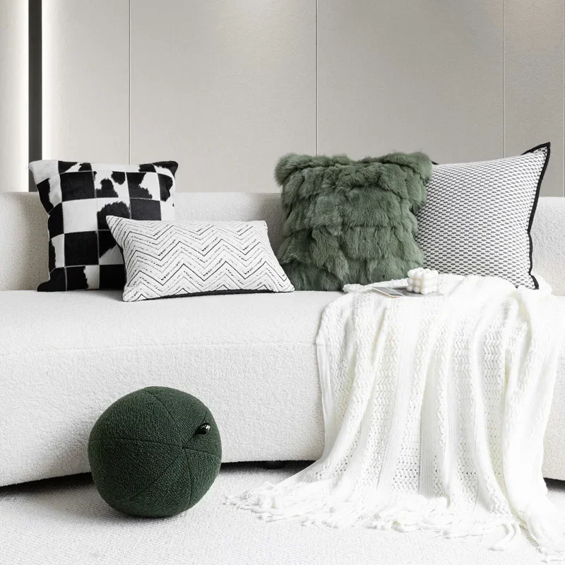 

Modern luxury living room sofa with combination of black and white genuine cowhide patchwork and green fox fur grass pillow cush