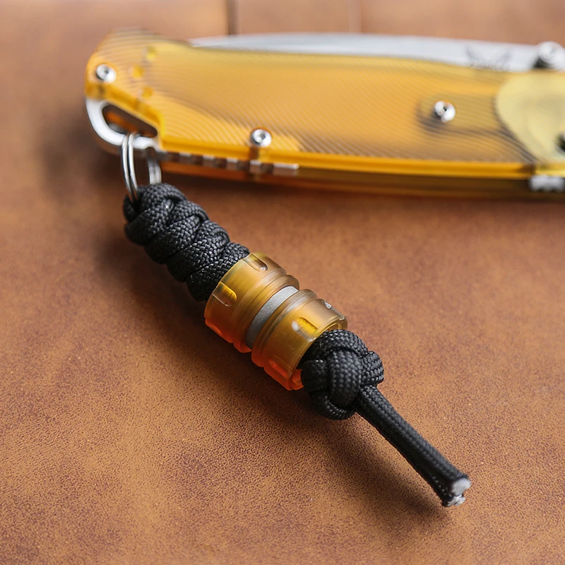 

New Titanium Alloy Three in One Outdoor Multifunctional Umbrella Rope Woven Key Pendant Amber EDC Resin Pendant