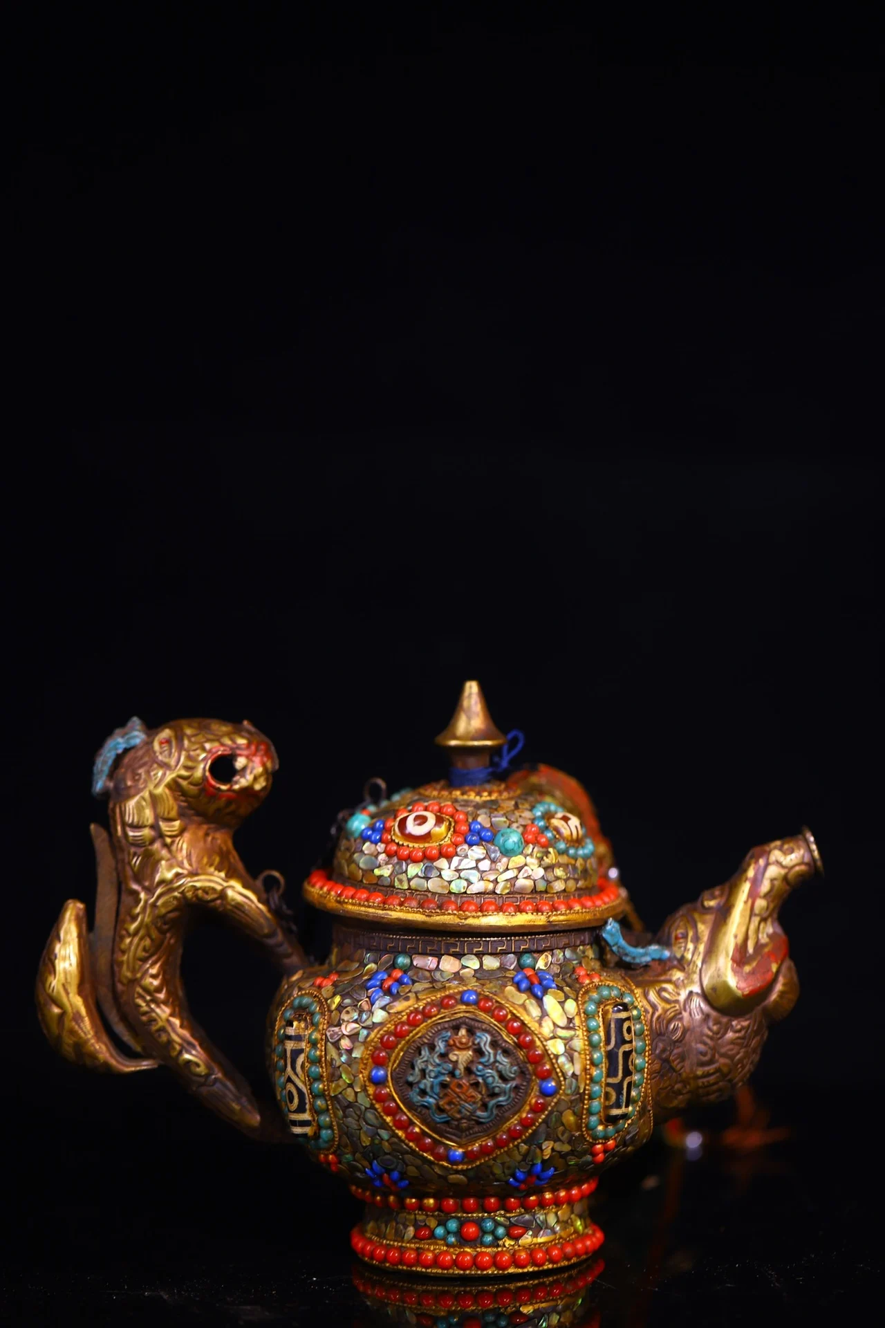 Handcrafted from pure Tibetan copper, set with gemstones, and featuring turquoise beads, this butter tea pot is a unique blend o