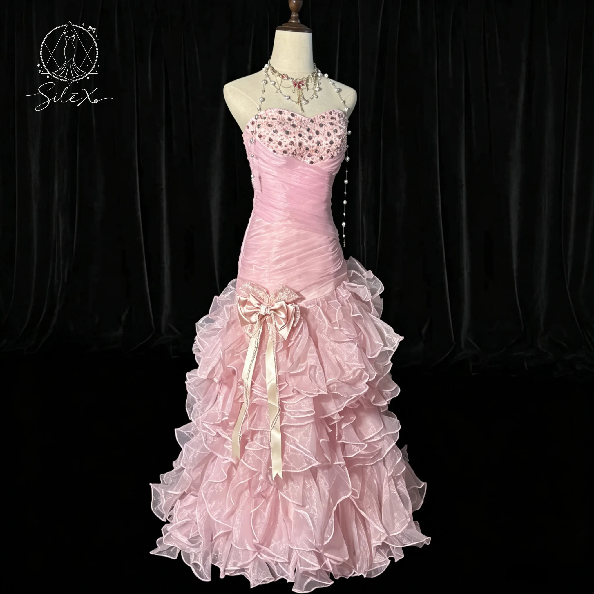 Pink strapless sleeveless fishtail floor-length formal ball gown with lace skirt and bow and sequin decoration