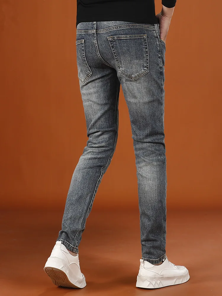 Pantalones rasgados de moda para hombre retro street 2025 nuevos pantalones vaqueros de pierna pequeña elásticos de gama alta de otoño