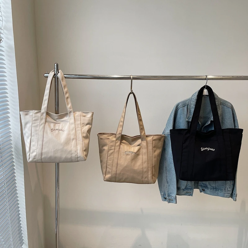 حقائب يد نسائية غير رسمية ذات سعة كبيرة ومتعددة الاستخدامات وسحاب موجز 2025 حقائب كتف جديدة عالية الجودة بلون واحد للتنقل