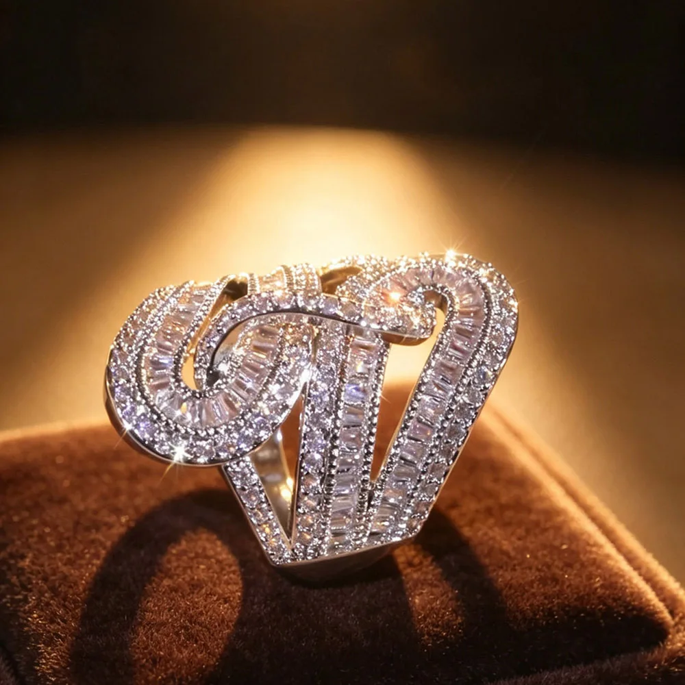 1Pcs oversized twisted S-curve hollow statement ring for women ladies, interlocking curved bands fully inlaid with baguette and round shiny zircon. Hollow layered design, glamorous and eye-catching for formal occasions.