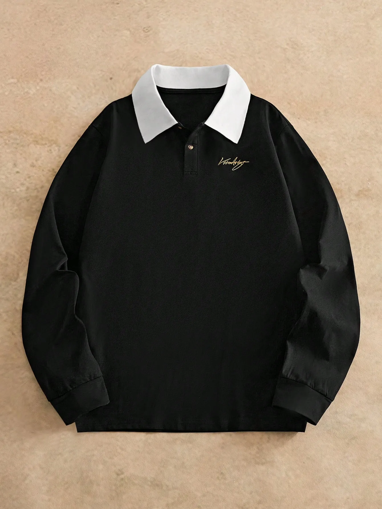 

Черная рубашка-поло с длинным рукавом, контрастным белым воротником и золотой вышивкой.