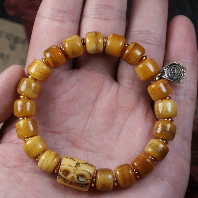 Tibetan natural cow bracelet with aged yak barrel and patinaed bone beads
